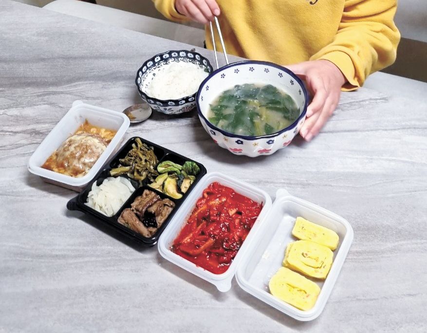 1. 굿네이버스 주말, 방학 식사지원 사업에 참여한 한 아동이 배달받은 반찬과 국으로 식사하는 모습.