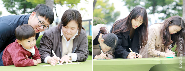 굿네이버스 세계빈곤퇴치의날 캠페인에 참여하여 희망리본에 빈곤퇴치에 대한 바램을 적고 있는 시민들 이미지